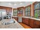 Bright kitchen with stainless steel appliances, granite countertops, wood floors, and many view-framing windows at 6021 Jibe Ct, Awendaw, SC 29429