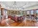 Spacious kitchen and dining area featuring a large center island, wood floors, and plentiful window views at 6021 Jibe Ct, Awendaw, SC 29429