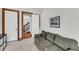 Living room featuring stairway access, light gray carpeting, neutral walls, and artwork at 6021 Jibe Ct, Awendaw, SC 29429