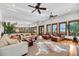 Expansive living area with hardwood floors, multiple seating areas, and seamless flow between spaces at 6021 Jibe Ct, Awendaw, SC 29429