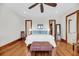 Bright main bedroom features beautiful hardwood floors, a ceiling fan, and access to walk-in closet at 6021 Jibe Ct, Awendaw, SC 29429