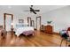 Spacious main bedroom featuring hardwood floors, a ceiling fan, and an abundance of natural light at 6021 Jibe Ct, Awendaw, SC 29429