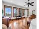 Sunlit main bedroom with views of the outdoors, featuring beautiful hardwood floors, and ceiling fan at 6021 Jibe Ct, Awendaw, SC 29429