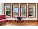 Bright home office with scenic outdoor views, complemented by hardwood floors and a functional desk setup at 6021 Jibe Ct, Awendaw, SC 29429