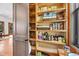 Walk-in pantry with filled shelves featuring an assortment of food, baskets, and cooking supplies at 6021 Jibe Ct, Awendaw, SC 29429