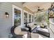 Inviting screened-in porch with comfortable seating and overhead ceiling fan at 6021 Jibe Ct, Awendaw, SC 29429