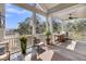 Covered porch featuring an outdoor grill, dining and seating area, plus serene views at 6021 Jibe Ct, Awendaw, SC 29429