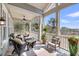 Screened-in porch with ceiling fan, comfortable seating, and serene views at 6021 Jibe Ct, Awendaw, SC 29429