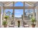 Cozy porch featuring chairs, decorative lanterns, and scenic views of the surrounding marshland at 6021 Jibe Ct, Awendaw, SC 29429