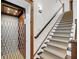 Bright staircase with carpet runner is adjacent to an open elevator with wood interior and folding metal gate at 6021 Jibe Ct, Awendaw, SC 29429