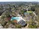 Aerial view of a neighborhood's community pool, tennis courts, and surrounding wooded landscape at 669 Palisades Dr, Mount Pleasant, SC 29464