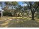 Lush backyard with mature trees, creating a serene and private atmosphere for the charming home at 669 Palisades Dr, Mount Pleasant, SC 29464