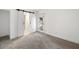 Open bedroom with plush carpeting and doorway leading outside with barn-style door at 669 Palisades Dr, Mount Pleasant, SC 29464