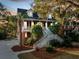 Charming brick home with a inviting double staircase and landscaped front yard, creating a picturesque curb appeal at 669 Palisades Dr, Mount Pleasant, SC 29464