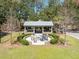 Outdoor fire pit seating area with a covered shelter and mature trees; an inviting spot for relaxation and community gathering at 669 Palisades Dr, Mount Pleasant, SC 29464