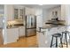 Spacious kitchen featuring stainless steel appliances, breakfast bar, and hardwood floors at 669 Palisades Dr, Mount Pleasant, SC 29464
