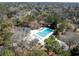 Aerial view of a community swimming pool and clubhouse in a wooded setting, providing a recreational amenity for residents at 669 Palisades Dr, Mount Pleasant, SC 29464