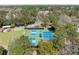 Aerial view of a community with well-maintained tennis and pickleball courts surrounded by lush greenery and a covered seating area at 669 Palisades Dr, Mount Pleasant, SC 29464