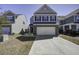 Charming two-story home featuring a brick facade and a two-car garage with a long driveway at 762 Redbud Ln, Summerville, SC 29486