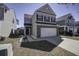 View of a two-story residence with brick and siding, a two-car garage, and a walkway to the front door at 762 Redbud Ln, Summerville, SC 29486