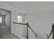 Hallway featuring carpet, railing, and a hanging light fixture at 762 Redbud Ln, Summerville, SC 29486