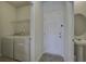 Well-lit laundry room and powder room off of entry from garage at 762 Redbud Ln, Summerville, SC 29486