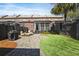 Private backyard with stone patio, screened porch, green lawn and grill, ideal for outdoor living and entertaining at 871 Center Park St, Charleston, SC 29492