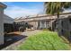 A private backyard with lush green grass, patio, privacy fence and cozy seating at 871 Center Park St, Charleston, SC 29492