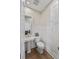 Charming powder room with pedestal sink, white wainscoting, and decorative accents at 871 Center Park St, Charleston, SC 29492
