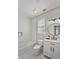 Modern, all-white bathroom with a sleek vanity, contemporary fixtures, and a bathtub with white subway tile surround at 871 Center Park St, Charleston, SC 29492