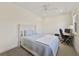 Inviting bedroom featuring a plush bed with a tufted headboard, a ceiling fan, and a dedicated workspace at 871 Center Park St, Charleston, SC 29492