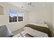 Cozy bedroom with a queen-sized bed, bright window, and ceiling fan, perfect for restful nights and relaxation at 871 Center Park St, Charleston, SC 29492