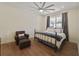 Cozy bedroom with hardwood floors, a ceiling fan, and a chair for relaxation at 871 Center Park St, Charleston, SC 29492