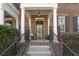 Inviting front entrance featuring brick stairs, iron railings, and a cozy rocking chair on the porch at 871 Center Park St, Charleston, SC 29492
