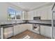 Bright kitchen features stainless appliances, white cabinets, and a window overlooking the yard at 871 Center Park St, Charleston, SC 29492