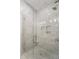 Elegant walk-in shower featuring marble tile, glass enclosure, and built-in shelving at 871 Center Park St, Charleston, SC 29492