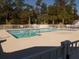 Outdoor swimming pool with metal ladders and white fencing at 8800 Dorchester Rd # 502, North Charleston, SC 29420