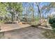 Spacious backyard with a brick patio and lush trees surrounding the property at 905 Battery Way, Mount Pleasant, SC 29464