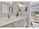 Bright bathroom featuring a double vanity with modern fixtures and a view to the exterior at 905 Battery Way, Mount Pleasant, SC 29464