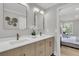 Bathroom vanity with double sinks, decorative mirrors, and a view to the bedroom at 905 Battery Way, Mount Pleasant, SC 29464