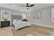 Bright bedroom features light gray walls, a ceiling fan, and a plush bed with a padded headboard at 905 Battery Way, Mount Pleasant, SC 29464