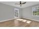 Bright bedroom with hardwood floors, a ceiling fan and two windows letting in natural light at 905 Battery Way, Mount Pleasant, SC 29464