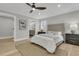 Bright bedroom features light gray walls, a ceiling fan, and access to an en suite bathroom at 905 Battery Way, Mount Pleasant, SC 29464