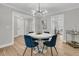 Dining room with a stylish table, chairs, and chandelier adjacent to an open kitchen at 905 Battery Way, Mount Pleasant, SC 29464