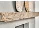 Textured fireplace mantel featuring decorative woven wall hangings and a rustic wood shelf at 905 Battery Way, Mount Pleasant, SC 29464