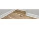 Close up of the light-colored hardwood floors and white baseboards at 905 Battery Way, Mount Pleasant, SC 29464
