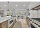 Open-concept kitchen features a kitchen island and a gas range stove at 905 Battery Way, Mount Pleasant, SC 29464