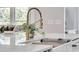 Close-up of kitchen island featuring brass faucet and modern marble countertop at 905 Battery Way, Mount Pleasant, SC 29464