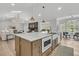 Open-concept kitchen island features a sink and microwave oven at 905 Battery Way, Mount Pleasant, SC 29464