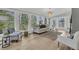Bright living room featuring floor-to-ceiling windows, hardwood floors, and stylish modern furniture at 905 Battery Way, Mount Pleasant, SC 29464